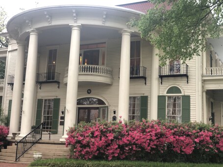 value: "A beautiful old home in a charming park in central Tyler. The architecture and furnishings of the home are all original since it was owned by the Goodman-LeGrand family. In spite of the recent storms, the azaleas on the property were still stunning."
