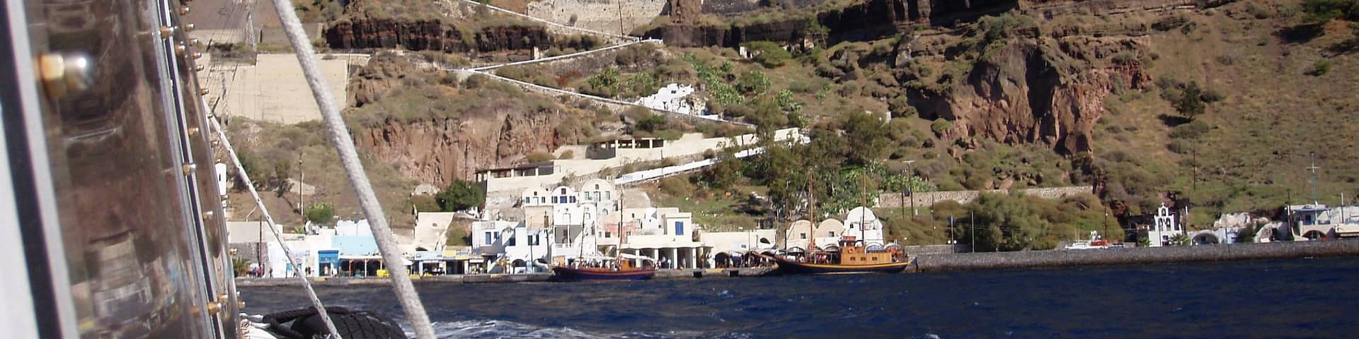 Grabbed this shot taking the ferry from the port of Santorini to an Island close by.  That zig zag path you see is how you in the old days got to the town of Fira, They now have a cable car.  But if you care for the hike, there are 588 stairs and takes a couple hours! Great view, love this place! just watch out for the donkey doo... you'll see.  Enjoy