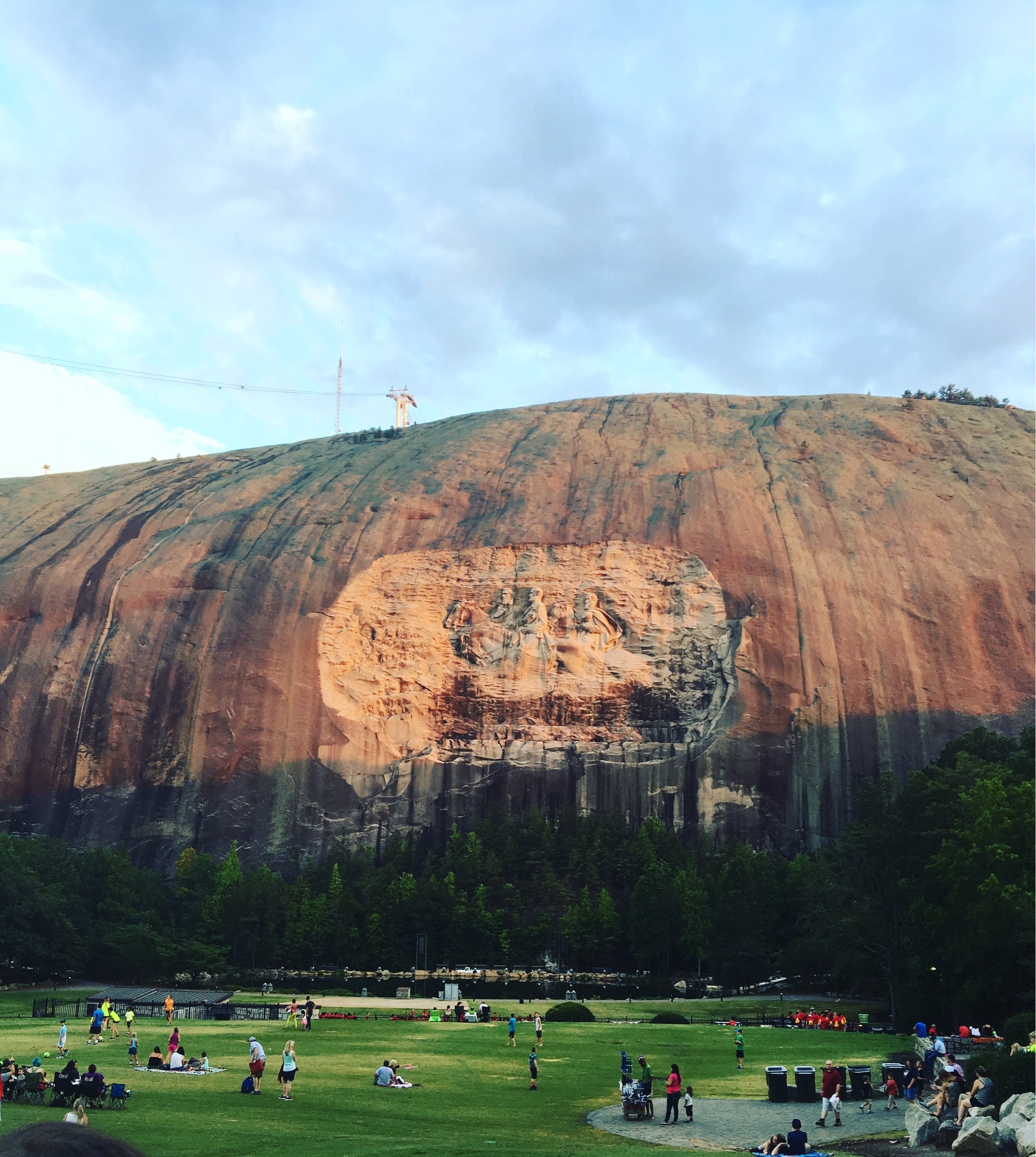As one watches the sun set over Stone Mountain (controversial Confederate general monument and all), the color of the rock deepens and puts on a beautiful show ❤️ #bruisedpassports