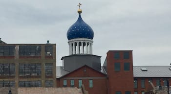 Underneath that blue dome lies the east armory of a factory once owned by a man who changed American history, the innovator of the revolver, Samuel Colt. Sprawling around the crumbling red brickwork of the old Colt’s Patent Firearms Manufacturing Company, once the largest private armory in the world, are the remnants of Coltsville, the utopian village he built for his workers. 

A model of 19th century industrial paternalism, Coltsville included a church, a social hall for dances and lectures, workers’ housing, a giant landscaped park home to deer and peacocks, sculpted botanical gardens, and thousands of feet of greenhouses filled with tropical fruit and flowers. Samuel Colt felt such responsibility for the welfare of his workers outside the factory that he went so far as to build Potsdam Village, to replicate the feel of the German village from which he imported his skilled craftsmen to work in his willow ware factory.

The National Park Service began having on-site presence in 2015, with workshops and tours, including up into the Blue Onion Dome which affords magnificent views of downtown Hartford, the Connecticut River and Colt Park, formerly the back yard of Armsmear, Samuel & Elizabeth Colt’s mansion. By 2016, an NPS ranger had taken up residence in the South Armory and was giving walking tours of Coltsville.

The old South, East and North armories are under renovation and the two 1855 brownstone buildings, the oldest structures on site, will become the National Park Service Visitor Center. The armories themselves have been or are being renovated into apartments, offices and education facilities.