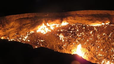 Alternatively called Derweze or the door to hell, this crater can be found in the Karakum desert of Turkmenistan, north of Ashgabat. While drilling in 1971, the Soviets tapped into this cavern filled with natural gas. They lit it thinking it would burn itself out in a matter of days. Not so, as you can see! It was mighty hot around the crater's edge, especially when there was a gust of wind. Can you see the people standing near the edge at the back in the middle? That will give you an idea of the size.