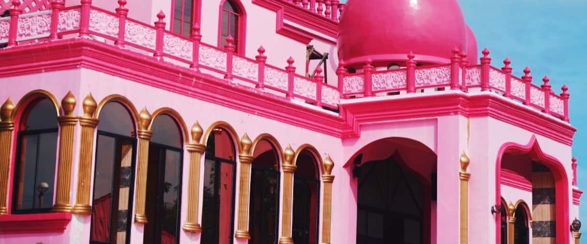 In the Philippines, specifically in Datu Saudi Ampatuan, Maguindanao, a noteworthy mosque that stands for peace has become quite a spectacular attraction. Can you guess what color? Yes. This is the Pink Mosque, or formally called, Masjid Dimaukom.
Masjid Dimaukom is clad in vibrant shades of pink – from the carnation-colored walls adorned by golden arches of its glass windows, to the lively cerise domes accented with silver spires, as well as silver star and crescents that face east. But that’s not it. The spacious interiors dominated by pink hues from its walls to the high ceilings, the shiny carmine of the tiled flooring, the bold golden pillars – the inside is equally captivating. This edifice is certainly an eye candy from inside out.
Beyond the structure’s aesthetic appeal, the Pink Mosque was built, primarily, as a sacred place of prayer, and also a symbol of peace. A unique structure that exemplifies harmony among Filipinos, regardless of religion, ethnicity, culture, and social class. The mosque is a brainchild of a man who believes in his love for the country, its people, and above all, the love for Allah.