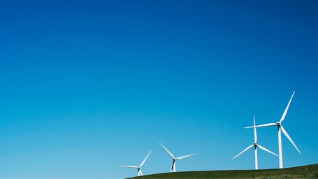 value: "Wind turbines spinning around majestically "
