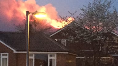 Moors fire behind houses in Carrbrook, Cheshire.