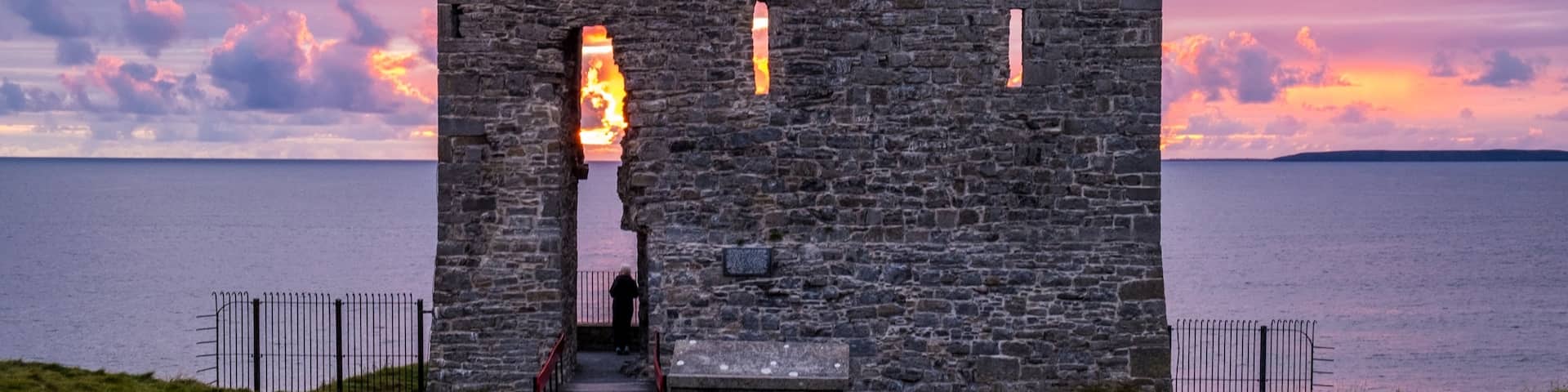 Sunset behind old castle ruins. Ballybunion, Co. Kerry, Ireland.