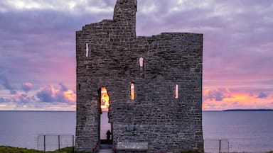 Sunset behind old castle ruins. Ballybunion, Co. Kerry, Ireland.