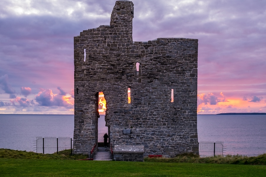 Sunset behind old castle ruins. Ballybunion, Co. Kerry, Ireland.