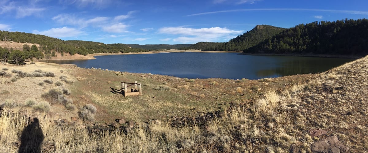 Quemado (burnt) Lake in central New Mexico is a relatively quiet recreation area with dropping water levels that have restored boat use, which is a gain for hikers who like to peacefully trek its 1.2 mile perimeter.