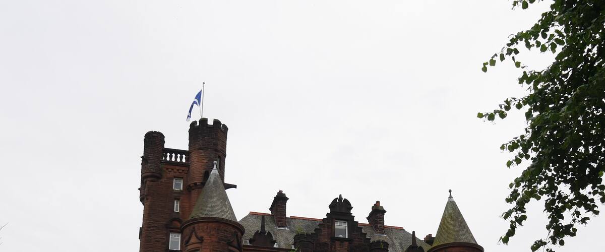 This castle is now a hotel in Glasgow. The grounds it sits on are lush, and within good walking distance from the train