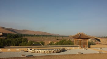 A rooftop view of the sand dunes and Gobi Desert in the distance.