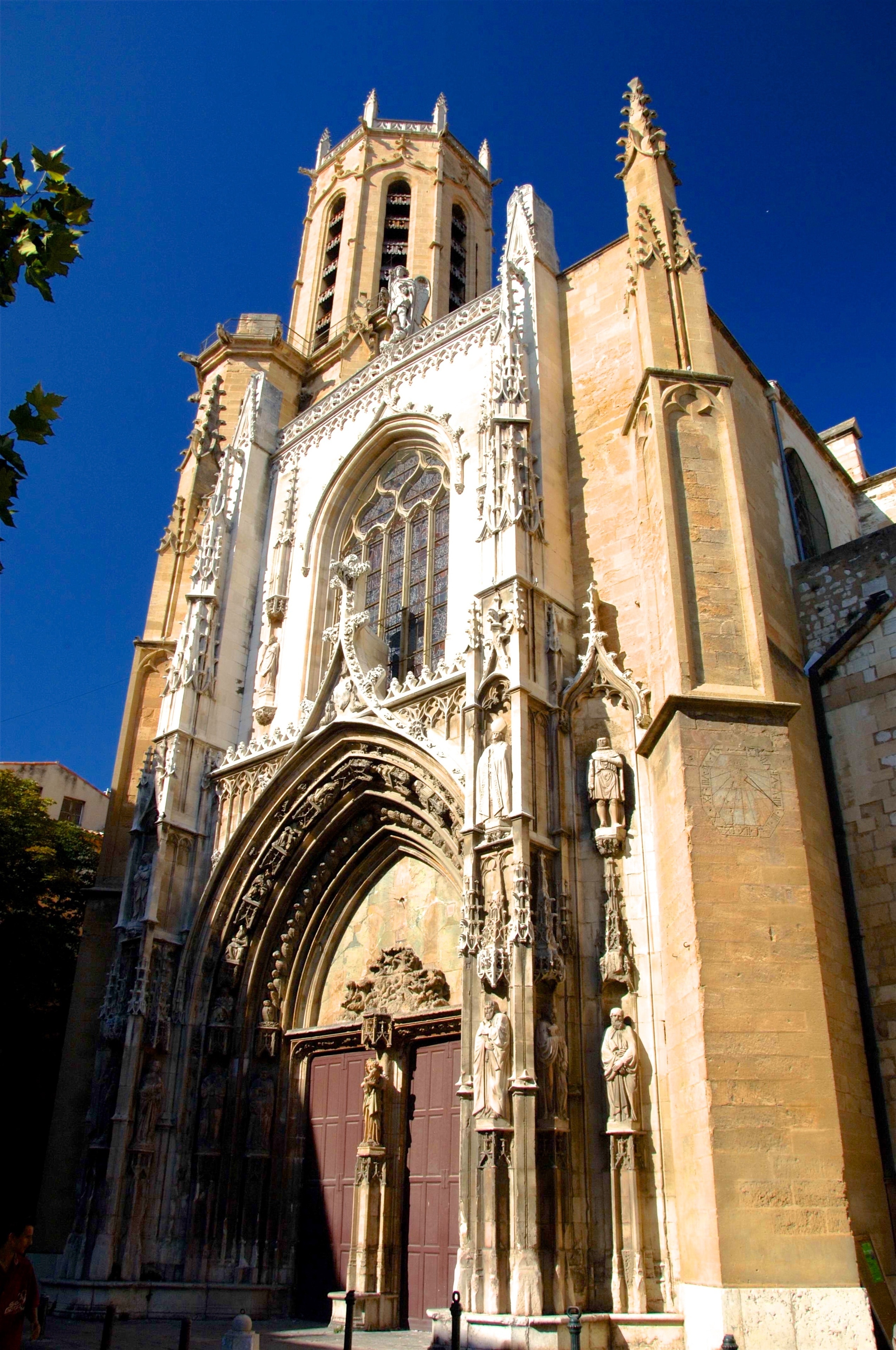 Gothic façade of the Saint Pierre Church in Avignon.  Located right in the center of town, a stone's throw from the Aubanel printing museum, the Place Saint Pierre, cobbled with shingle stones, is the church square for the parish church that bears the same name.

Saint-Pierre had been rebuilt in 1385, thanks to a donation from the Cardinal Pierre de Près. Unfortunately we cannot enter and admire the panelling, the altarpiece, the pulpit or the paintings, one of which is the "Adoration of the Shepherds" by Simon de Chalons. But its façade, in flamboyant Provençal Gothic, is the most embellished of all of Avignon's churches and its doors alone merit a look.