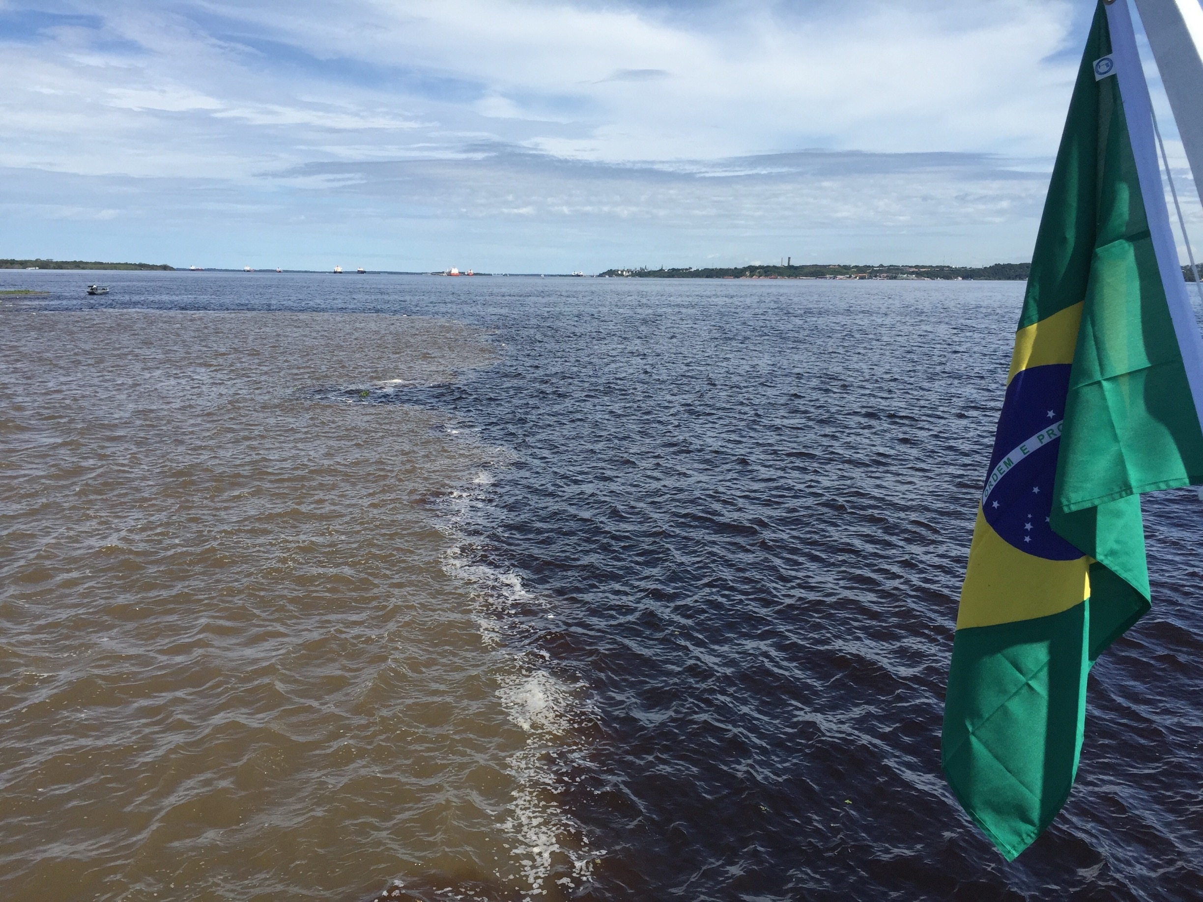 The Meeting of Waters (Portuguese: Encontro das Águas) is the confluence between the Rio Negro, a river with dark (almost black colored) water, and the sandy-colored Amazon River or Rio Solimões, as it is known the upper section of the Amazon in Brazil. For 6 km (3.7 mi) the river's waters run side by side without mixing. It is one of the main tourist attractions of Manaus, Brazil. 

This phenomenon is due to the differences in temperature, speed and water density of the two rivers. The Rio Negro flows at near 2 km per hour at a temperature of 28°C, while the Rio Solimões flows between 4 to 6 km per hour at a temperature of 22°C. [1]