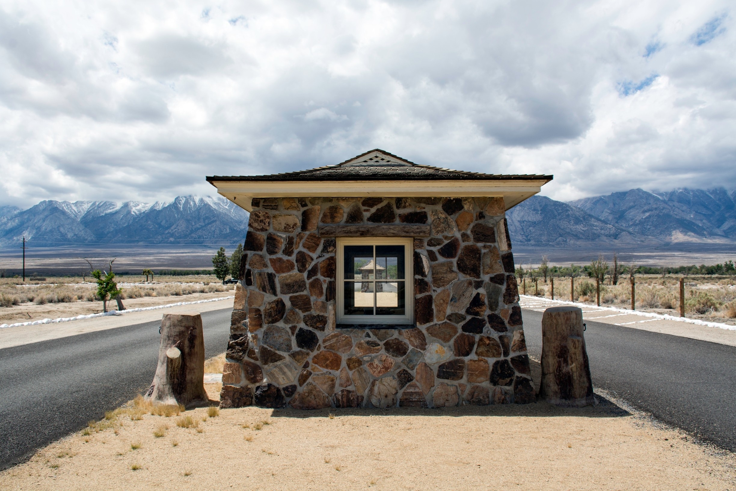 Gatehouse at Manzanar, most famous of the ten concentration camps, or "relocation centers" built to house Japanese-Americans and Japanese aliens during the Second World War. Nearly 120,000 people, two-thirds of them U.S. citizens, were removed from their homes, primarily on the west coast, to the camps inland. When I was a kid, riding up U.S. 395 to a camping or hiking trip in the Sierras, these gatehouses were the most visible parts of what remained of the camp. Manzanar has since become a National Historic Site, with an interpretive center housed in the camp's former auditorium and reconstructed barracks with exhibits documenting the lives of the internees.