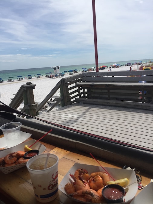 Beachfront view at James Lee Park with soft white sand and clear Gulf waters in Destin, Florida.
