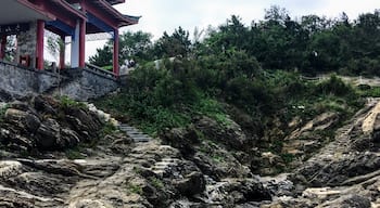 Looking up from the rocky coast at the small pagoda by the sea.