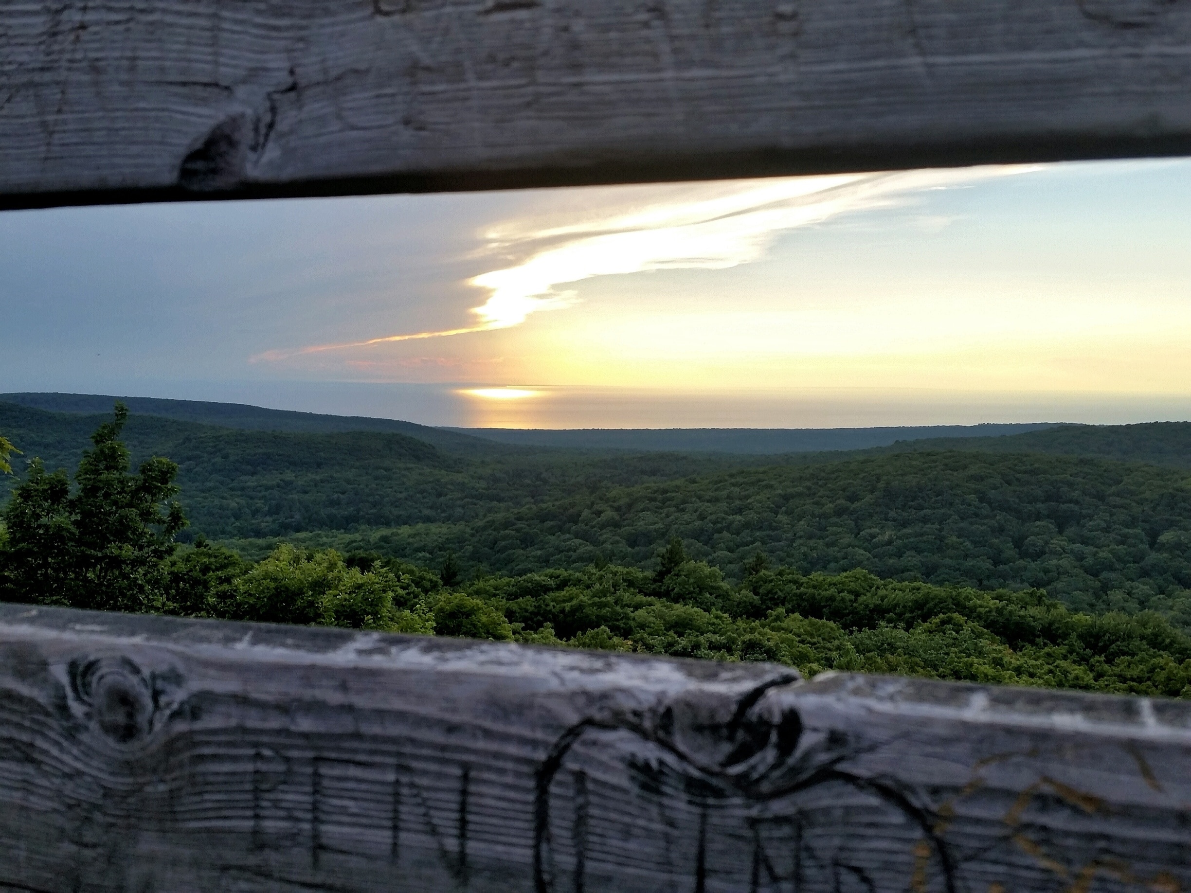 Between the wooden planks of the Summit Peak tower is an incredible view +1958 ft up. A must see just a dozen miles from the Porcupine Mountains visitors center. 