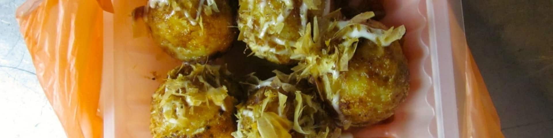 "Takoyaki"
These little round balls of yumminess are light and squishy and filled with different ingredients like cheese, pork, or octopus.  Then covered with a sweet soy sauce and mayonnaise and fishy flakes.  We ate them with small skewers.  These were the appetizers to more delicious delights!!