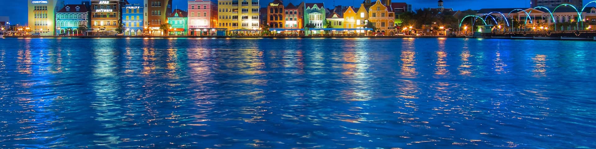 The harbor view in the port area of Willemstad at night