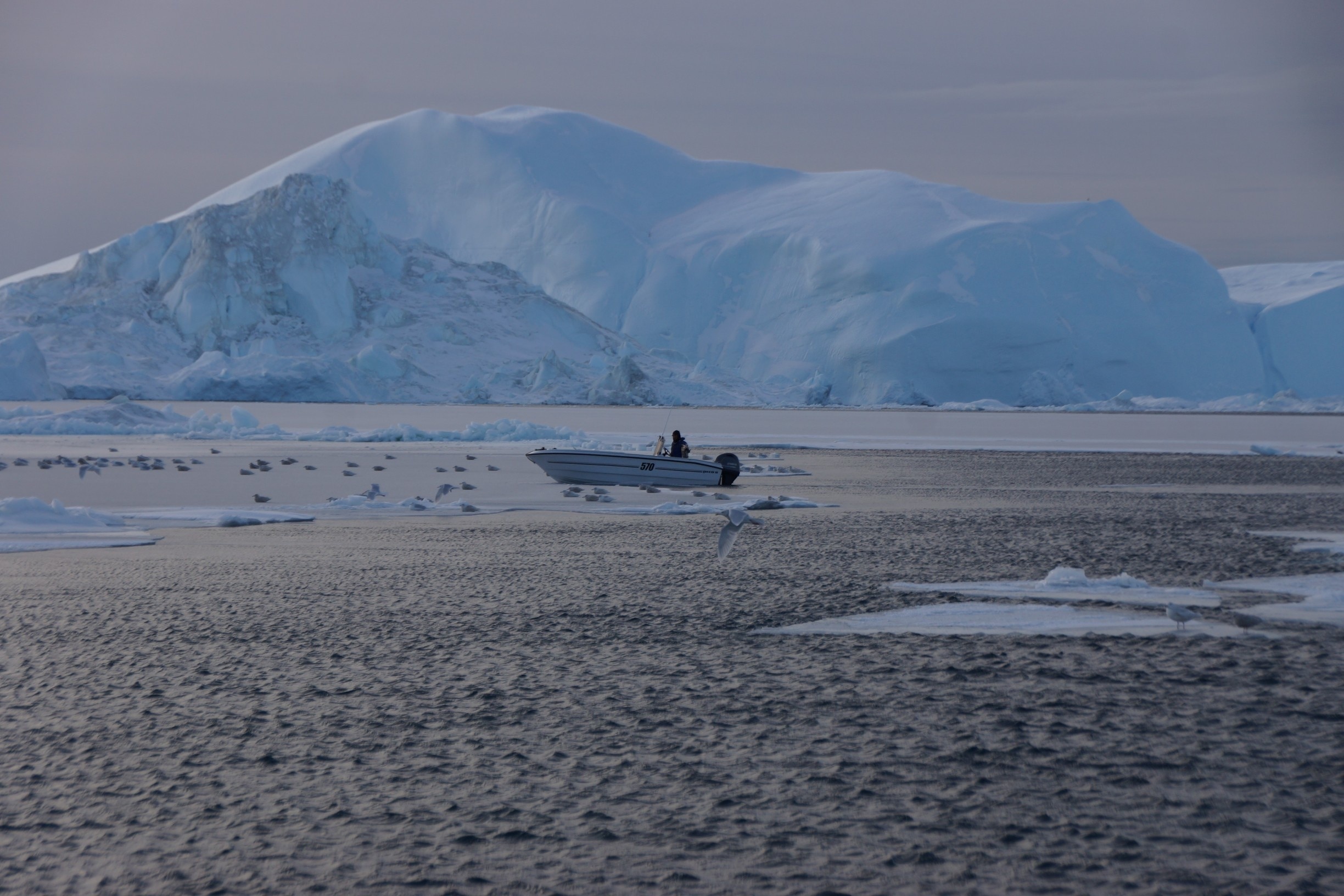 Locals out fishing.  Their boats were markedly smaller than our boat, which meant they could maneuver through the sheet ice more easily.