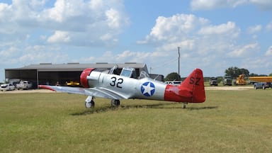 A visiting North American T-6G at Old Kingsbury Aerodrome, with a newly-acquired Piper J-3 Cub in the background.