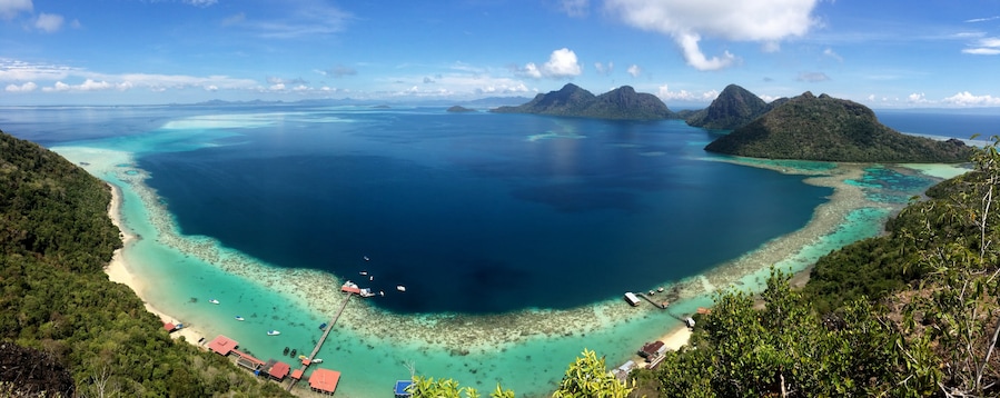 Ask a boatman at the Semporna dock to bring you to Bohey Dulang. From the jetty it is a short but sweaty hike to this viewpoint. The waters down here in the Tun Sakaran marine park are excellent for snorkling and cooling down after your hike :-)