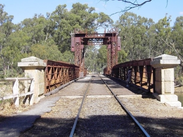 The Tocumwal Historic Bridge
The Tocumwal Rail Bridge over the Murray River was built in 1895 as a road bridge. When the railway arrived in 1908 it was strengthened and was used for both road and rail traffic until November 1987. A concrete road bridge was provided for road traffic a short distance upstream, with the old bridge used for rail traffic only since that time.