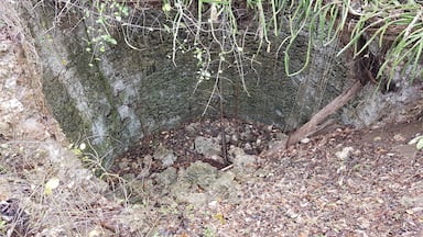 Old well, 18th Century, presently non functional, approx 20 feet deep, 15 feet diameter, part of the structure caved inn.