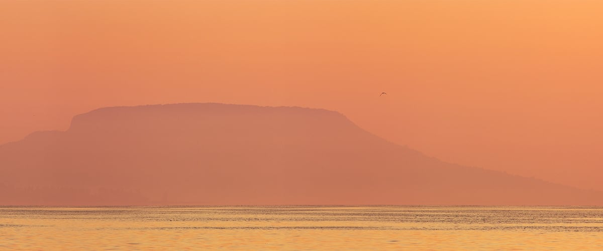 #golden
The Badacsony is a mountain top on the north shore of Lake Balaton. The settlement lying next to the mountain and region also shares the name Badacsony. The entire area is recognized for its wine, with vineyards dating back to Roman times. This basalt mountain is a unique geological relic.