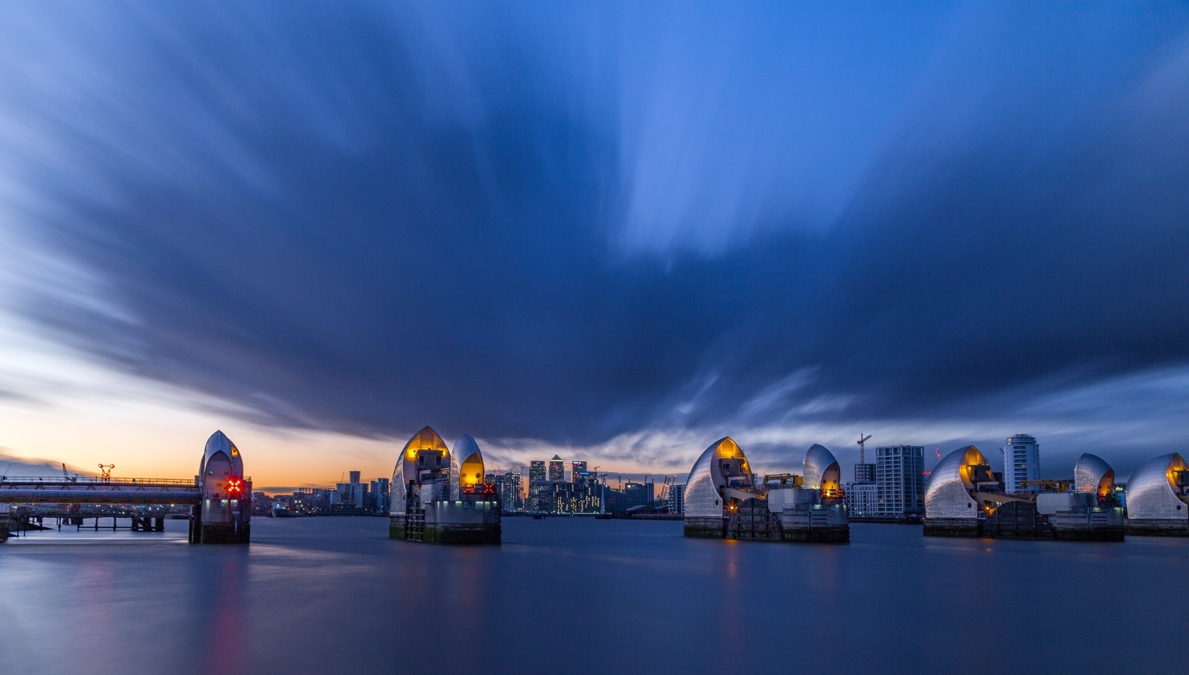 The Thames Barrier from the eastern side by the Viewpoint Cafe, with Canary Wharf in the background.

Although last night was pretty windy and chilly, the light was pretty nice with big clouds moving in the sky.

I even had the chance (i.e. I did not plan it this way) to get there around when the tide was flipping direction.  The barrier was up when I arrived and they pulled it back when the tide started to go down.