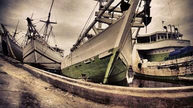 The Phinisi line up at Sunda Kelapa Harbour

Sunda Kelapa is the old port of Jakarta located on the estuarine of Ciliwung River. "Sunda Kalapa" (Sundanese: "Coconut of Sunda") is the original name, and it was the main port of Sunda Kingdom of Pajajaran. The port is situated in Penjaringan sub-district, of North Jakarta, Indonesia. Today the old port only accommodate pinisi, a traditional two masted wooden sailing ship serving inter-island freight service in the archipelago. Although it is now only a minor port, Jakarta had its origins in Sunda Kelapa and it played a significant role in the city's development.

The pinisi or phinisi is a traditional Indonesian two-masted sailing ship. It was mainly built by the Konjo tribe, a sub-ethnic group of Bugis-Makassar mostly residents at the Bulukumba regency of South Sulawesibut was, and still is used widely by the Buginese andMakassarese, mostly for inter-insular transportation, cargo and fishing purposes within Indonesian archipelago.

