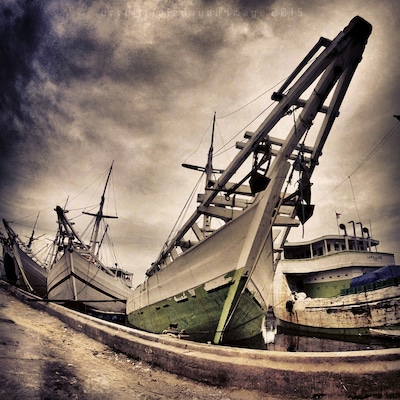 The Phinisi line up at Sunda Kelapa Harbour
Sunda Kelapa is the old port of Jakarta located on the estuarine of Ciliwung River. "Sunda Kalapa" (Sundanese: "Coconut of Sunda") is the original name, and it was the main port of Sunda Kingdom of Pajajaran. The port is situated in Penjaringan sub-district, of North Jakarta, Indonesia. Today the old port only accommodate pinisi, a traditional two masted wooden sailing ship serving inter-island freight service in the archipelago. Although it is now only a minor port, Jakarta had its origins in Sunda Kelapa and it played a significant role in the city's development.
The pinisi or phinisi is a traditional Indonesian two-masted sailing ship. It was mainly built by the Konjo tribe, a sub-ethnic group of Bugis-Makassar mostly residents at the Bulukumba regency of South Sulawesibut was, and still is used widely by the Buginese andMakassarese, mostly for inter-insular transportation, cargo and fishing purposes within Indonesian archipelago.