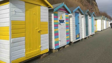 Stunning little sheltered beach with colourful huts ☀️