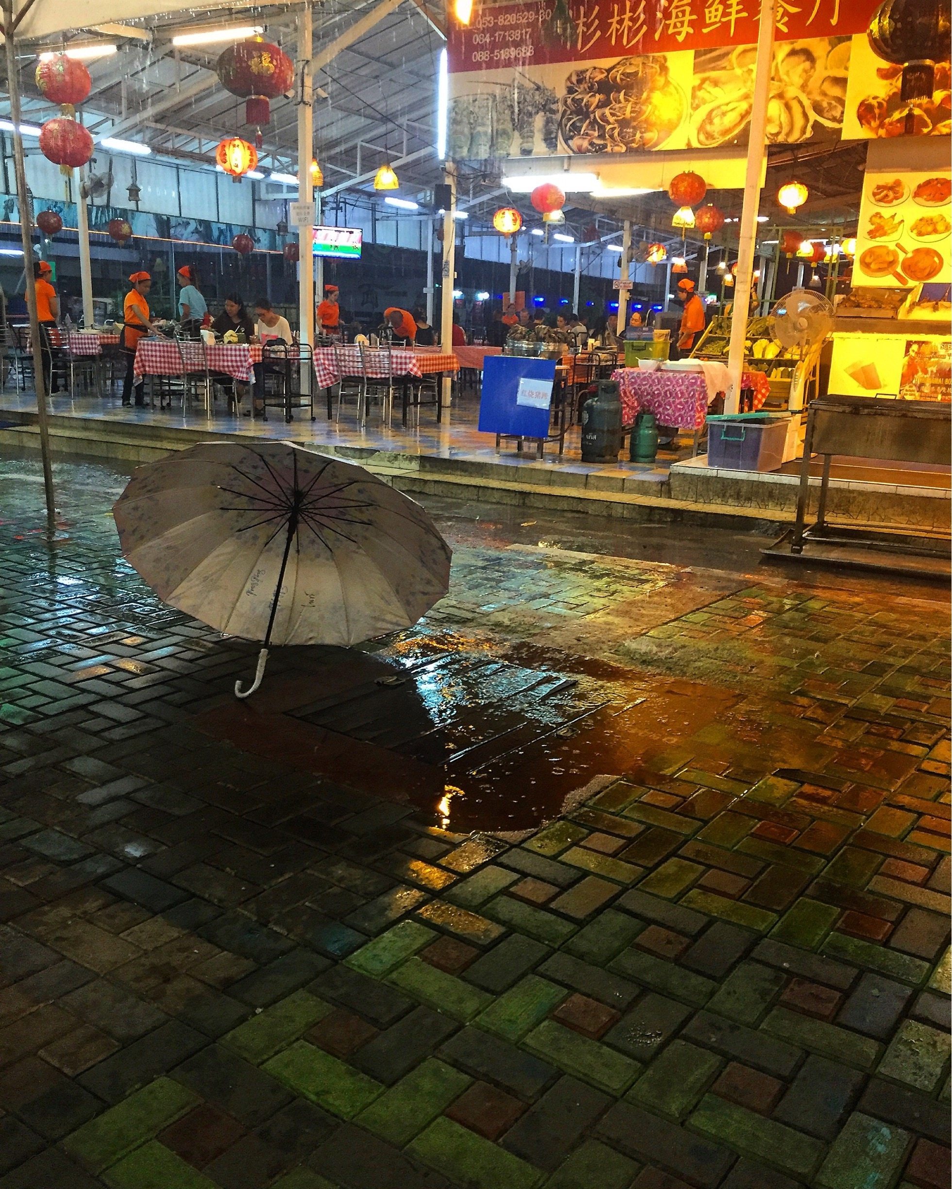 Rainy night at the night bazaar. 

The night bazaar in Chiang Mai's old town is a wonderfully colorful   market, tables full of local handicrafts. Restaurants and roti stands line the perimeter, making it a great spot to spend an evening. Crowding the sidewalks outside this covered marketplace, local vendors stretch for blocks selling anything from knock-off designer bags to carved wooden statues. Get ready to haggle....