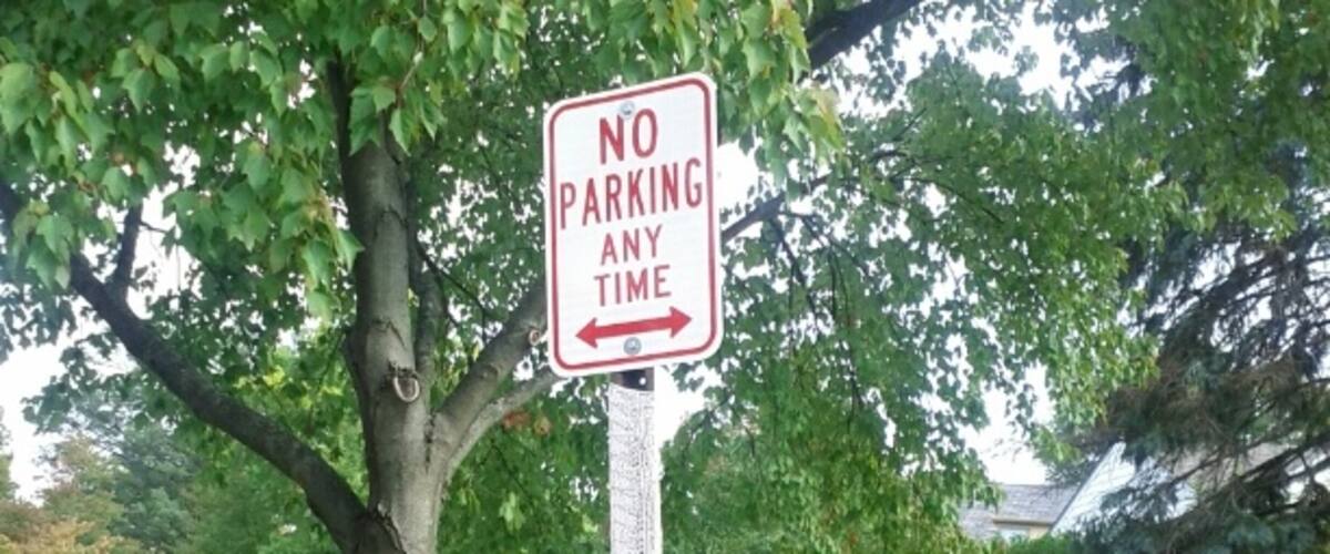 A yarn-bombed no parking sign.