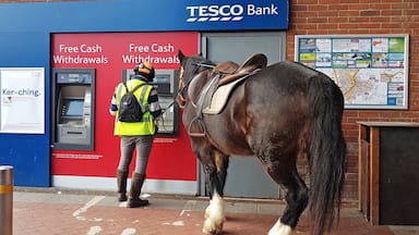 Not a sight you see every day and I wouldn't usually post a photo of a person at a cashpoint machine!

However, this guy in Hailsham, East Sussex  just rode up on his horse, jumped off and got his cash. Looks like the horse knows his pin number now!