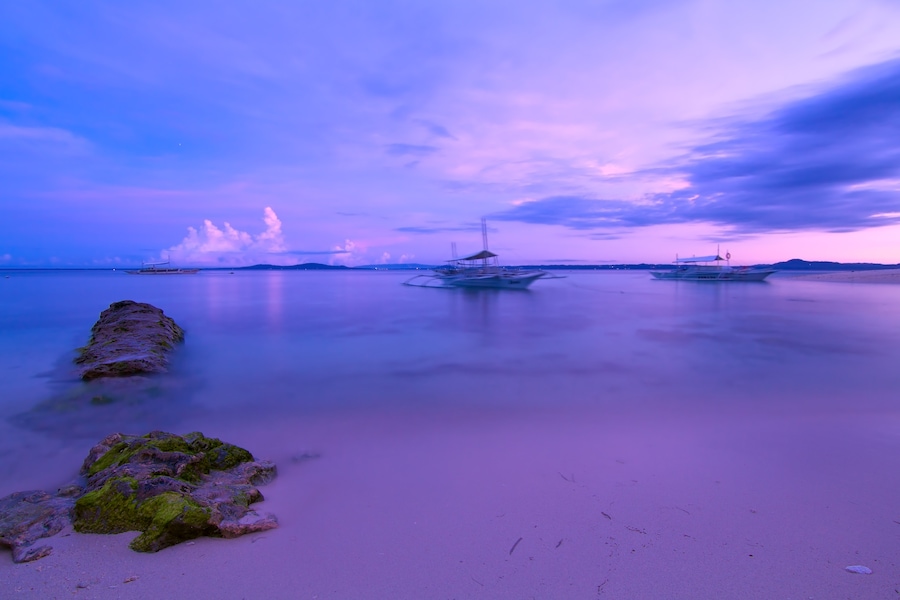 Waking up to surreal colors on the shores of Pamilacan Island in Bohol before sunrise.