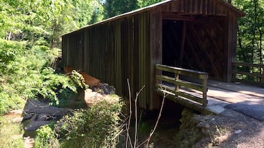 Originally built in 1897 this bridge was moved here in 1924 to support a grist mill that was here. It is one of only a handful of covered bridges in Georgia that are still in use. 