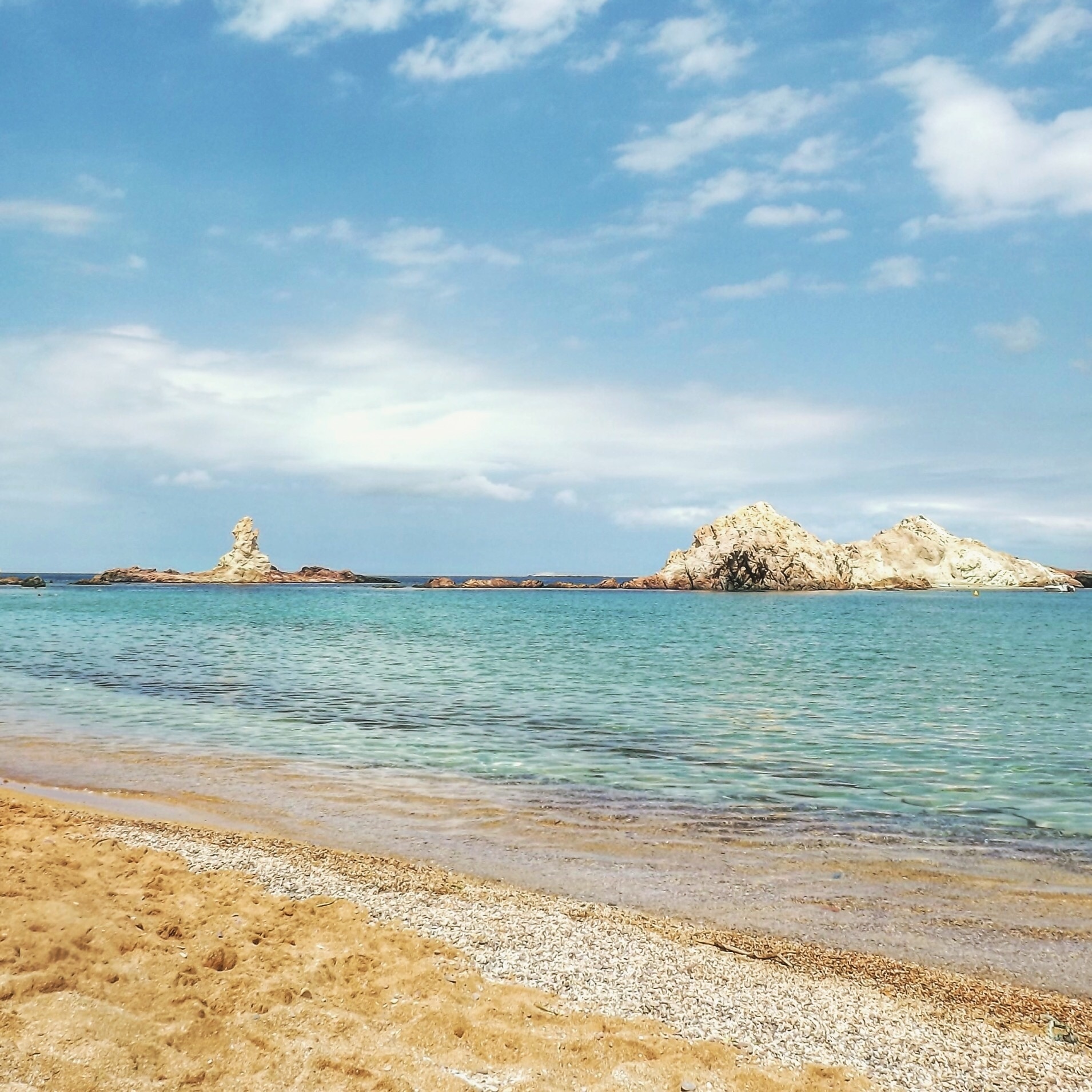 Cala Pregonda in Menorca island (Spain). A perfect place to admire the combination of orange, blue and white colors.
