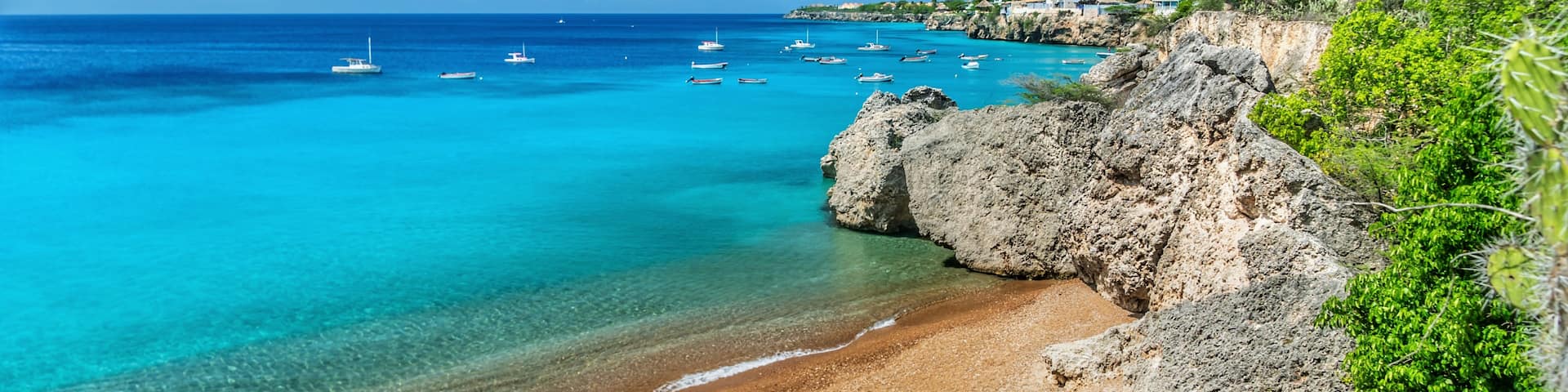 Small beach where fishing boats come in. Fish are cleaned and remains fed to the turtles. You can snorkel around the beach any time of day and see many turtles