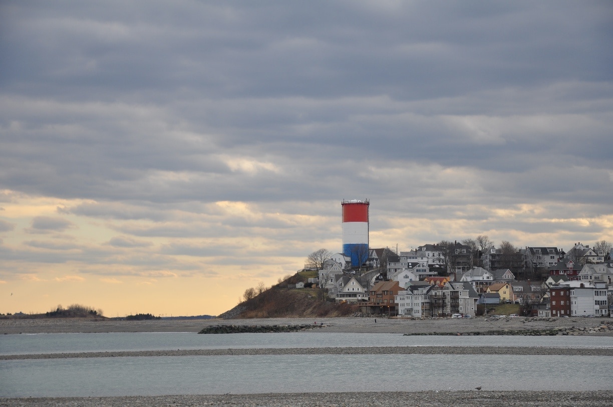 As seen from Deer Island, this is the town of Winthrop, just north of Boston, MA.  It's a cute, condensed town with houses stacked right on top of each other on the hills.  The long beach (the end of which you can see in the photo) is a great place to walk in winter, and of course is packed in the summer.  Get there early to find a parking space!