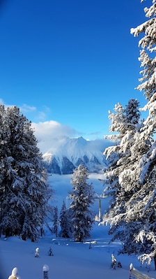 The view down to Nauder from the kids ski school nauders. Glories sunny day on top of the mountains