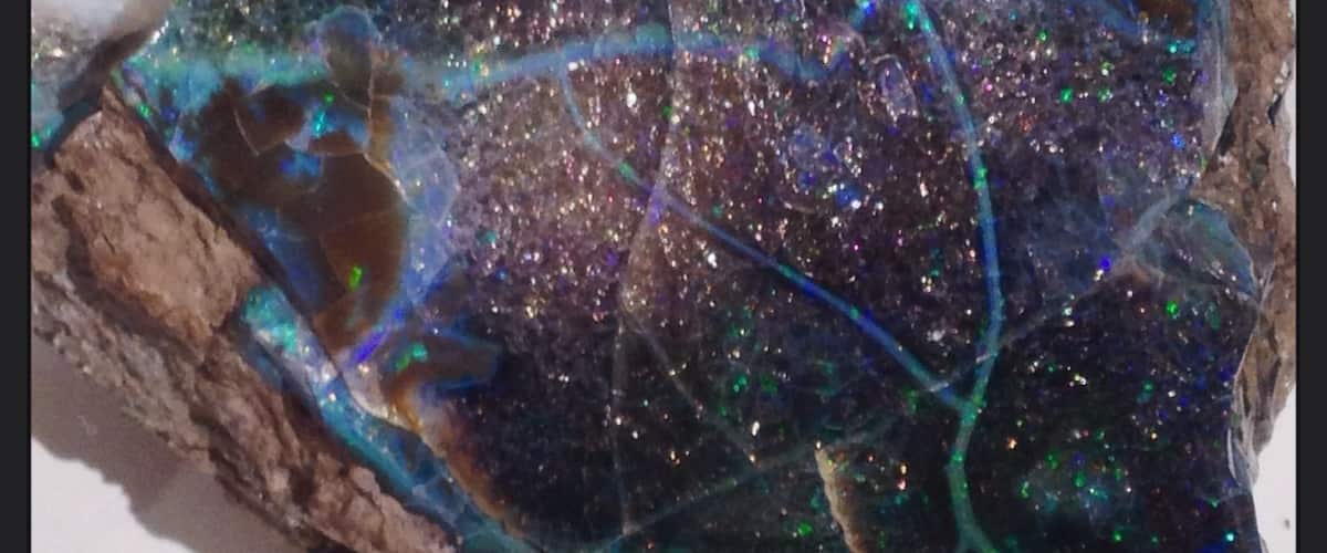 There is an entire galaxy that dwells within the dusty, dull exterior of this Opal.