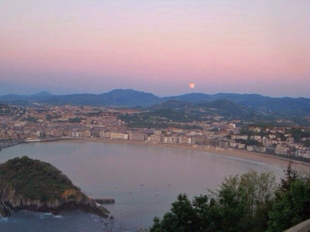 San Sebastián at sunset. Short hike or gondola ride to the top of the viewpoint. There's an awesome old school amusement park at the top of the mountain