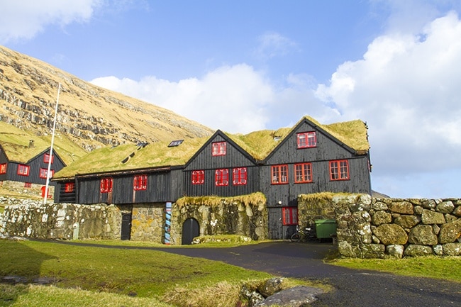 The hike from Torshavn to the old bishopric and royal residence where the Norwegian King Sverre grew up, takes a few hours. In the Middle Ages Kyrkjebo was the cultural and religious center in the Faroe Islands. The old log house is told to be Europe’s oldest timber building, around 900 years old. John Patursson is the host and farmer at Kyrkjebo, he’s 17. generation onsite. Read more on: http://www.travelwithallsenses.com/faroe-islands-treat-for-all-senses/