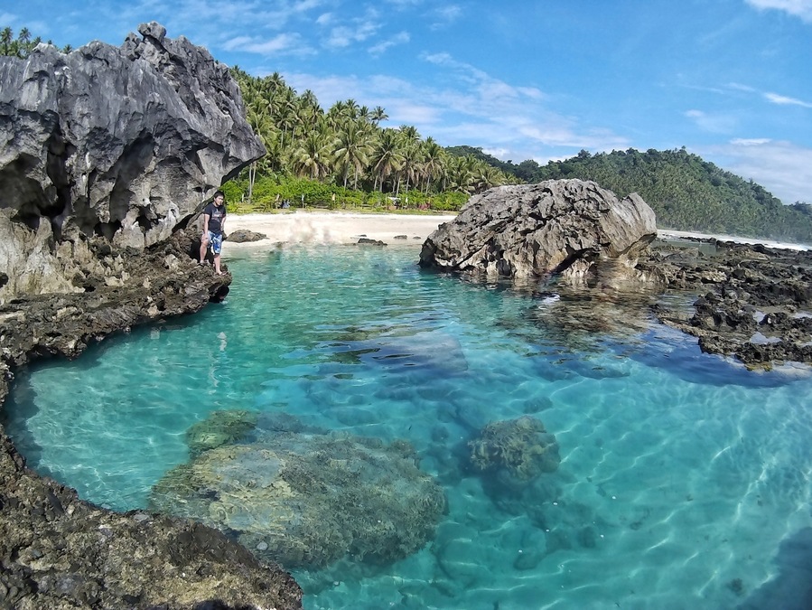 The Tibu Tidal Pool in San Ildefonso, Casiguran Aurora Philippines. Amazing rock formations, crystal clear water, and white sand stunning long coastline.