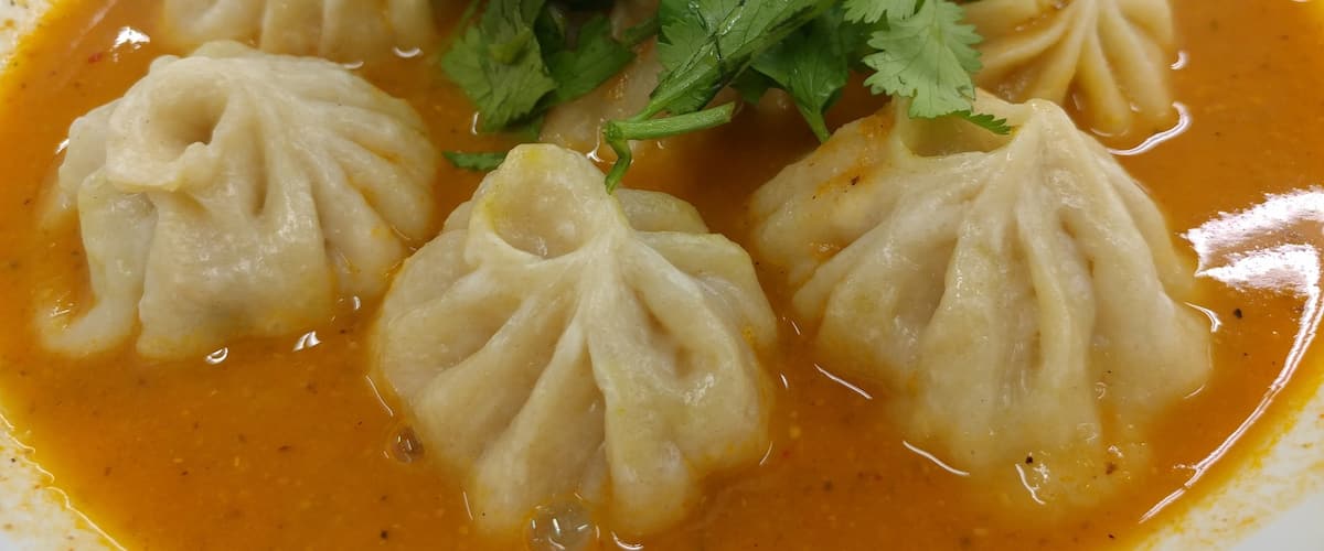 Inside the Saraga International Market is the not so hidden gem of Nepalese delights, Momo Ghar. A tiny stall in a giant grocery adventure. The Jhol Momo is the go to dish. Dumplings filled with chicken and a unique seasoning that's hard to put a finger on. They're served in a spicy broth that's worth getting some extra bread to sop up the remnants.