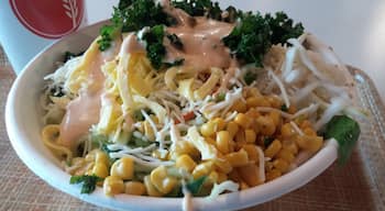 Bibibop Asian Grill is the Asian equivalent of the Chipotle style of dining.

A bowl filled with wild purple rice, bean sprouts, sauteed potatoes, chicken, cucumber, lettuce, carrot, daikon, cheese, corn and egg topped with yum yum sauce.