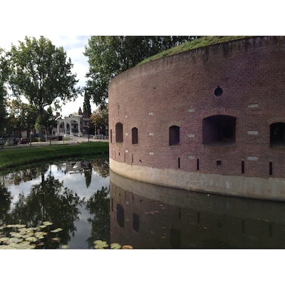 When you are interested in military history, the fortresses of the defense line of Amsterdam are a must see. Build around 1900, it consists of some 46 fortresseses, batteries, dikes, dams and locks. The enemy was partly kept out by inundating the land outside the defense line. The invention of the airplane was a real spoiler for military strategists...
Note: this fortress, Bastion de Bakkerschans, is not open to the public, but many other fortresses are. http://www.stellingvanamsterdam.nl/en/home