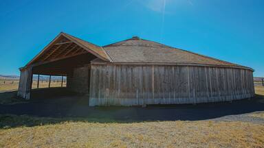 The Pete French Round Barn stands in the heart of Harney County and remains a monument to one man’s livestock empire. Peter French arrived in 1872 and began amassing land and cattle. By the mid-1880s, his enterprise had grown to 70,000 acres and 45,000 head of cattle.

Some claimed he didn’t legally acquire the land or water rights, which prompted land disputes and court cases and added to his controversial reputation. One of the disputes eventually led to his murder in 1897.

Although dubbed the ‘Cattle King,” French was the first rancher in the area to put up hay. He also raised thousands of sheep for their wool. The Round Barn was used to train wild horses to pull long wagon trains full of wool, hay and supplies to market in Oregon City.

In today’s landscape, this type of barn is unique. But during 1880–1920, round barns became popular in the Midwest where they were promoted as being efficient for progressive methods of farming.  

The Round Barn is near the Malheur National Wildlife Refuge, a network of wetlands that attract diverse bird and wildlife species. As you drive through the area, take in the sweeping views of the high buttes surrounding the low plains and marshes and the picturesque Steens Mountain towering in the distance.
#Oregon #PeteFrench #roundbarn #extremeOregon