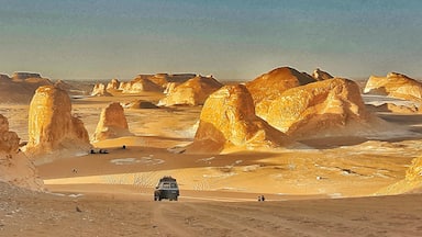 Sunset light simply paints the calcite/lime rocks  golden hue  from white.
The huge rocks look out of the world